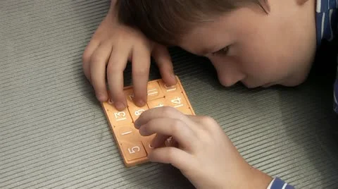 Boy collects puzzles Stock Footage 12227784