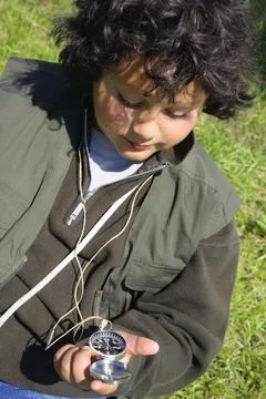 Boy With A Compass Stock Photos