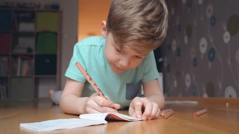 Boy concentrating and thinking. Child studying homework and writing Stock Footage 123201677