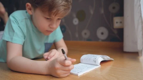 Boy concentrating and thinking. Child studying homework and writing Stock Footage 123201706