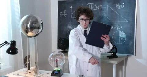 A boy conducts physical experiments with electricity, a plasma ball, and a Van Stock-Footage 173396539