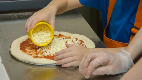 The boy cooking pizza in the pizzeria Stock Footage 142402508