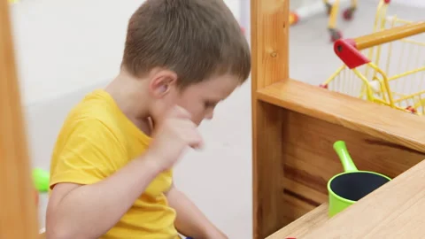 Boy cooking in toy kitchen. Stock Footage 266993728