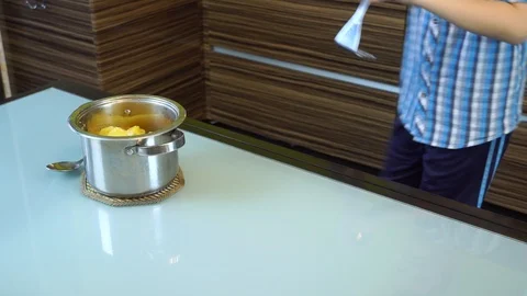 Boy cooks mashed potatoes in the kitchen on the table Stock Footage 99224095