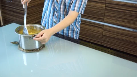 Boy cooks mashed potatoes in the kitchen on the table Stock Footage 99224284