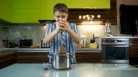 Boy cooks mashed potatoes in the kitchen on the table Stock Footage 99225703