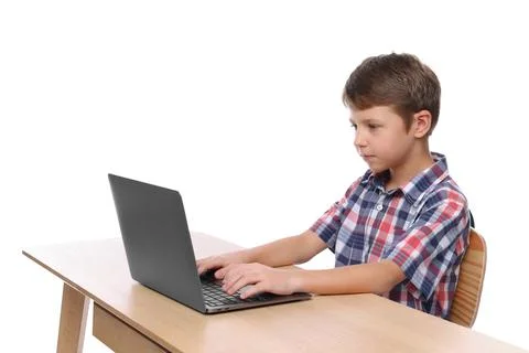 Boy with correct posture using laptop at wooden desk on white background Stock Photos