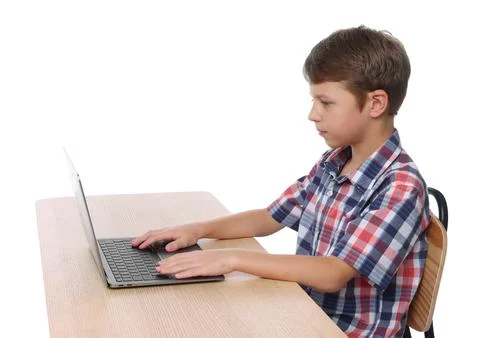 Boy with correct posture using laptop at wooden desk on white background Stock Photos