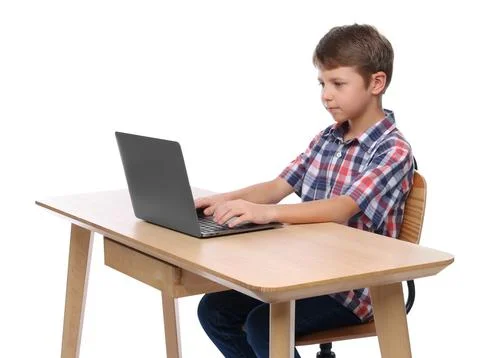 Boy with correct posture using laptop at wooden desk on white background Stock Photos