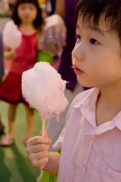 Boy with cotton candy Stock Photos