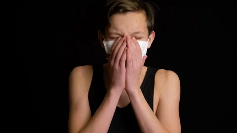 Boy Coughs into mask. Stock Footage 123858365