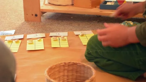 Boy Counting Numbers with Pebbles Stock Footage 46634080