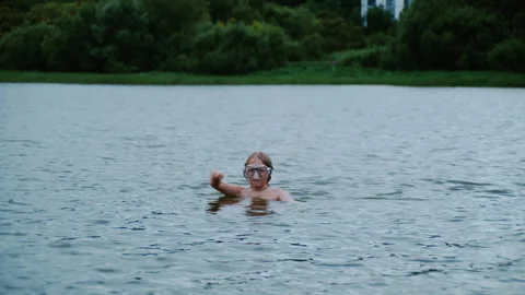 Boy Counting to Three Before Diving into Lake Stockbeeldmateriaal 344682326