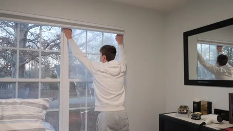 Boy Covering Window to Save Energy Background for Home Efficiency Stock Footage 327680168