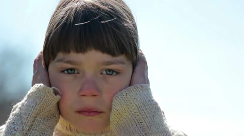 Boy covers his ears with his hands Stock Footage 37015039