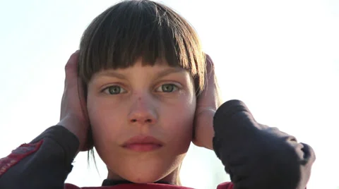 Boy covers his ears with his hands Stock Footage 37119254