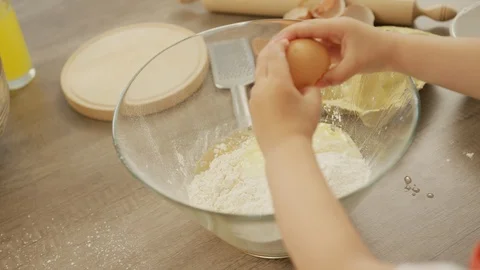 Boy cracking an egg Stock Footage 100000635