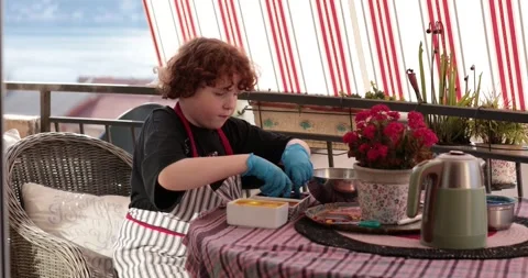 Boy creates Easter eggs and step of egg painting process in a cozy setting Video stock 306066501