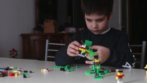 Boy creating toys with blocks Stock Footage 85688718