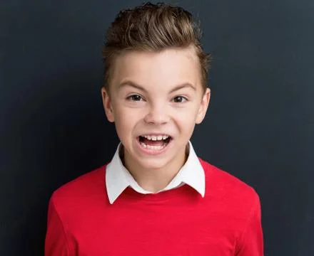 Boy crying at the black chalkboard Stock Photos