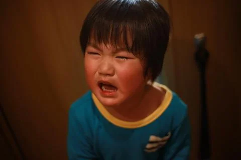Boy crying at the door Stock Photos