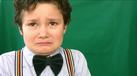 Boy crying in front of a green screen | Stock Video | Pond5