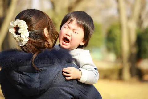 Boy crying with mother Stock Photos