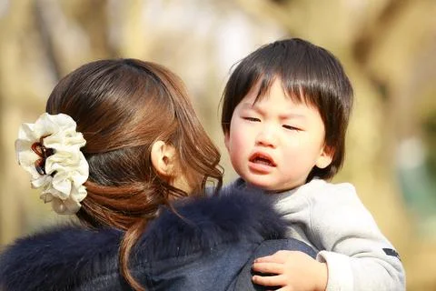 Boy crying with mother Stock Photos