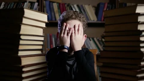 Boy curly doesn't want to learn facepalm Video stock 146060308