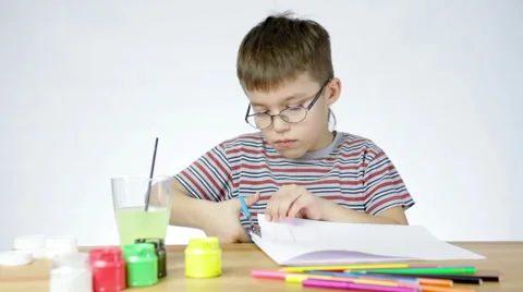 Boy cuts paper with scissors Stock Footage 47413444