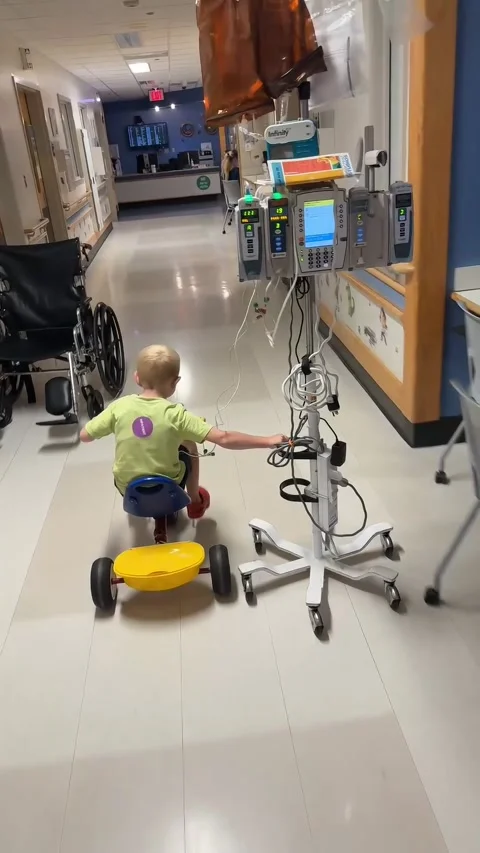 Boy Cuts A Turn While Riding Bike Through Hospital, Cincinnati, Ohio, USA - 25 J Stock Footage 345089702