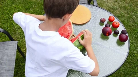 Boy Cutting Fresh Watermelon Into Pieces 스톡 동영상 341811666