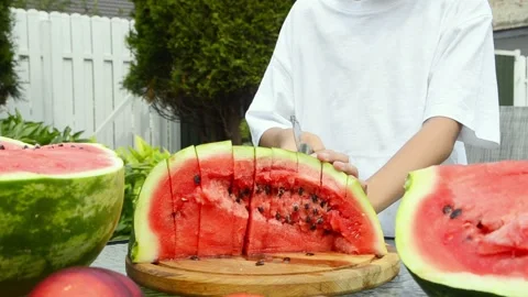 Boy Cutting Fresh Watermelon Into Pieces Stock Footage 341811742