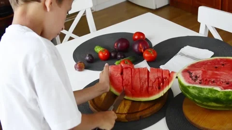 Boy Cutting Fresh Watermelon Into Pieces Stock Footage 341812063
