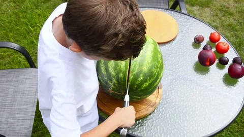 Boy Cutting Fresh Watermelon Into Pieces Stock Footage 341812388