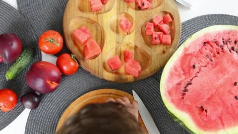 Boy Cutting Fresh Watermelon Into Pieces Видео 341812504
