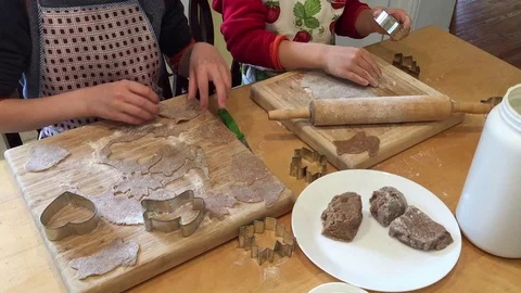 Boy cutting out cookies from a rolled out dough Stock Footage 128546014