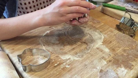 Boy cutting out cookies from a rolled out dough Stock Footage 128546989