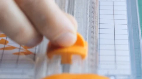 Boy cutting a sheet of paper in two with the paper cutter Stock-Footage 123355866