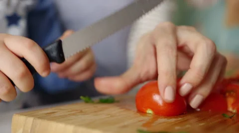 Boy cutting tomato Stock Footage
