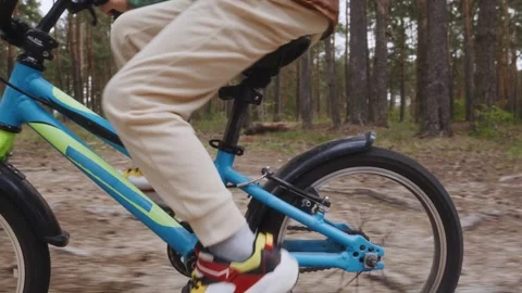 Boy cycling on forest path close up of bike frame Stock Footage 315756648