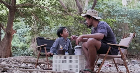 Boy with dad enjoying camping in the forest with camping tent Stock Footage 168917834