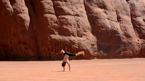 Boy dancing breakdance in the famous Monument Valley USA Stock Footage 40385733