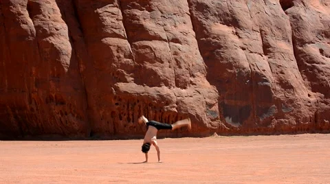Boy dancing breakdance in the famous Monument Valley USA Stock Footage 40385734