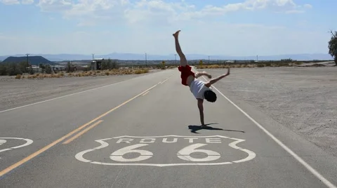 Boy dancing breakdance in the famous route 66 road Stock Footage 40367249
