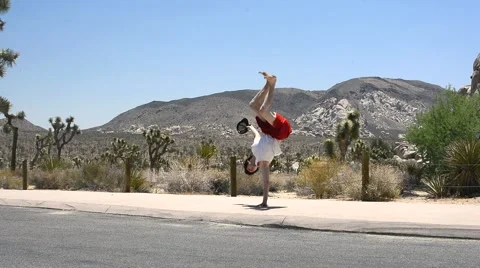 Boy dancing breakdance in the Joshua Tree Stock Footage 40367239