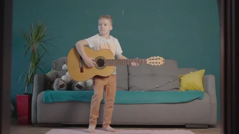 Boy dancing with guitar at home. funny guy Stock Footage 165357083