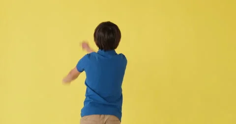 Boy dancing over yellow background Stock Footage 145235809