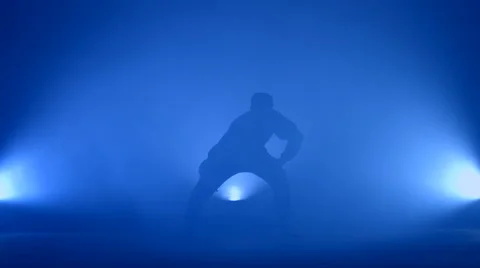 Boy dancing in a smoke on a blue background Stock Footage 63082457