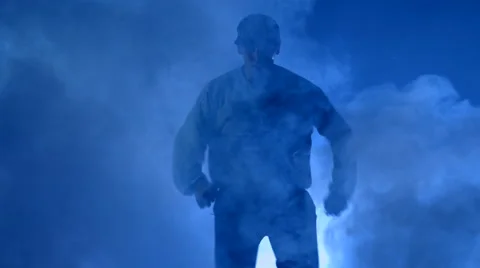 Boy dancing in a smoke on a blue background Stock Footage 63084411